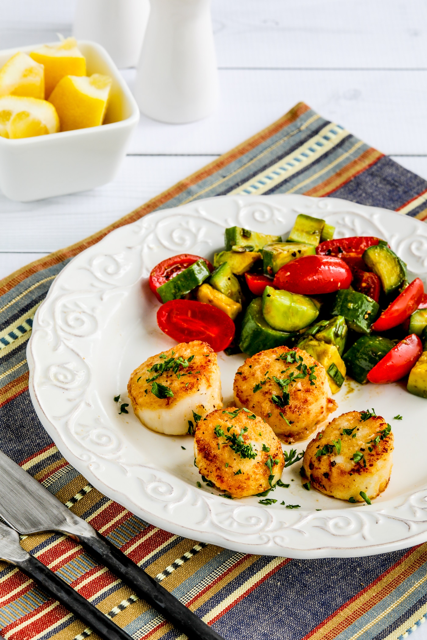 Sauteed Scallops with Garlic, close-up of finished scallops on serving plate with Tomato Cucumber Avocado Salad