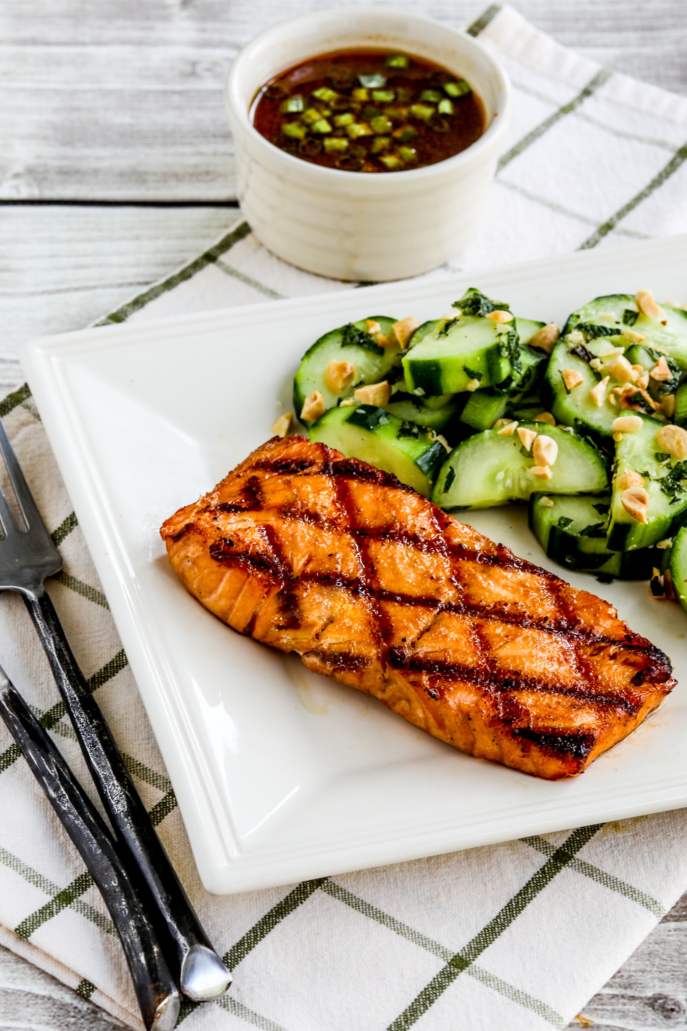 Korean salmon with dipping sauce as shown in the serving dish with Thai cucumber salad