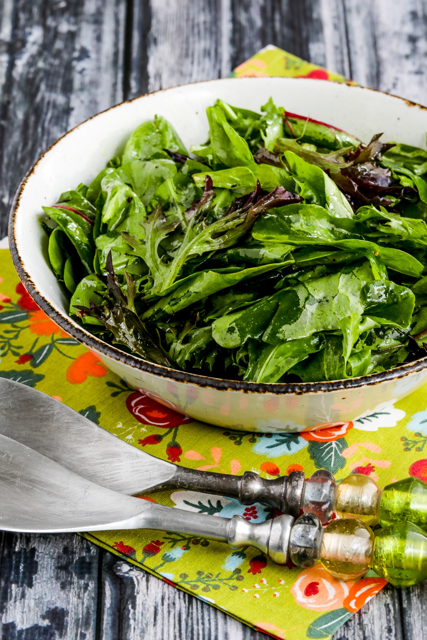 cropped image of Mary's Perfect Easy Dressing for Spring Mix Salad Greens salad in bowl with two serving forks