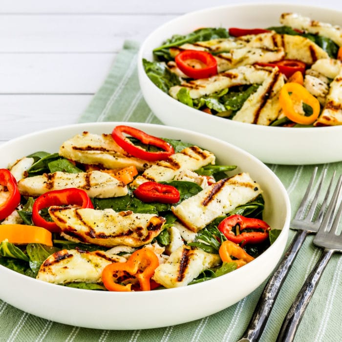 Square image of Grilled Halloumi Salad showing salad in two large serving bowls