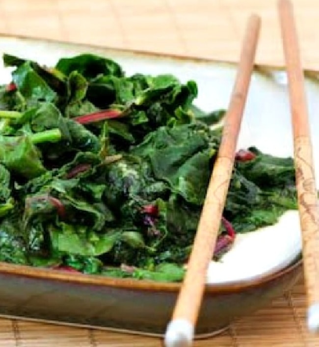 Stir-Fried Radish Greens and Swiss Chard cropped image on serving plate with chopsticks