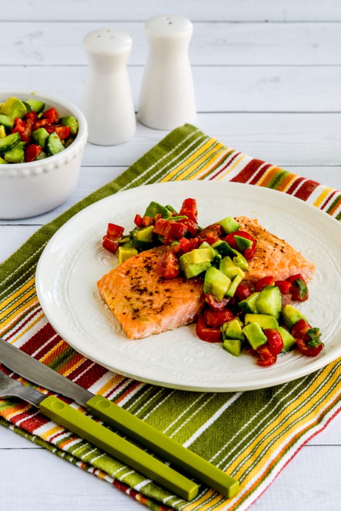 Roasted Salmon with Avocado Salsa cooked salmon on serving plate with bowl of salsa