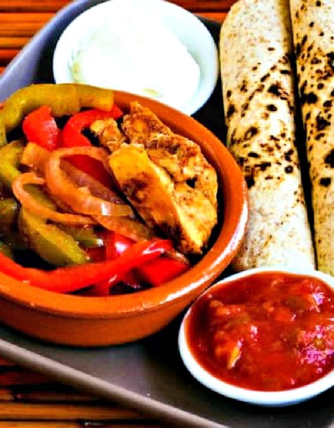 Slow-cooker chicken fajitas served with low-carb tortillas, sour cream and salsa.