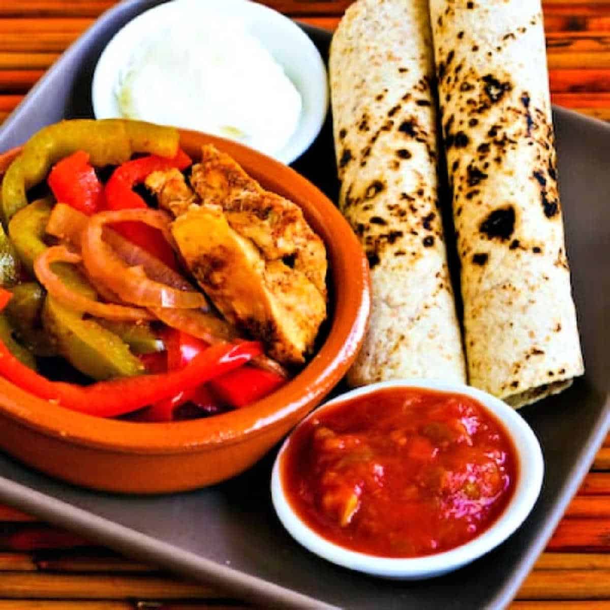 Slow cooker chicken fajitas shown in single servings on a square plate.