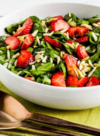 Square image of Strawberry Spinach Salad shown in serving bowl.