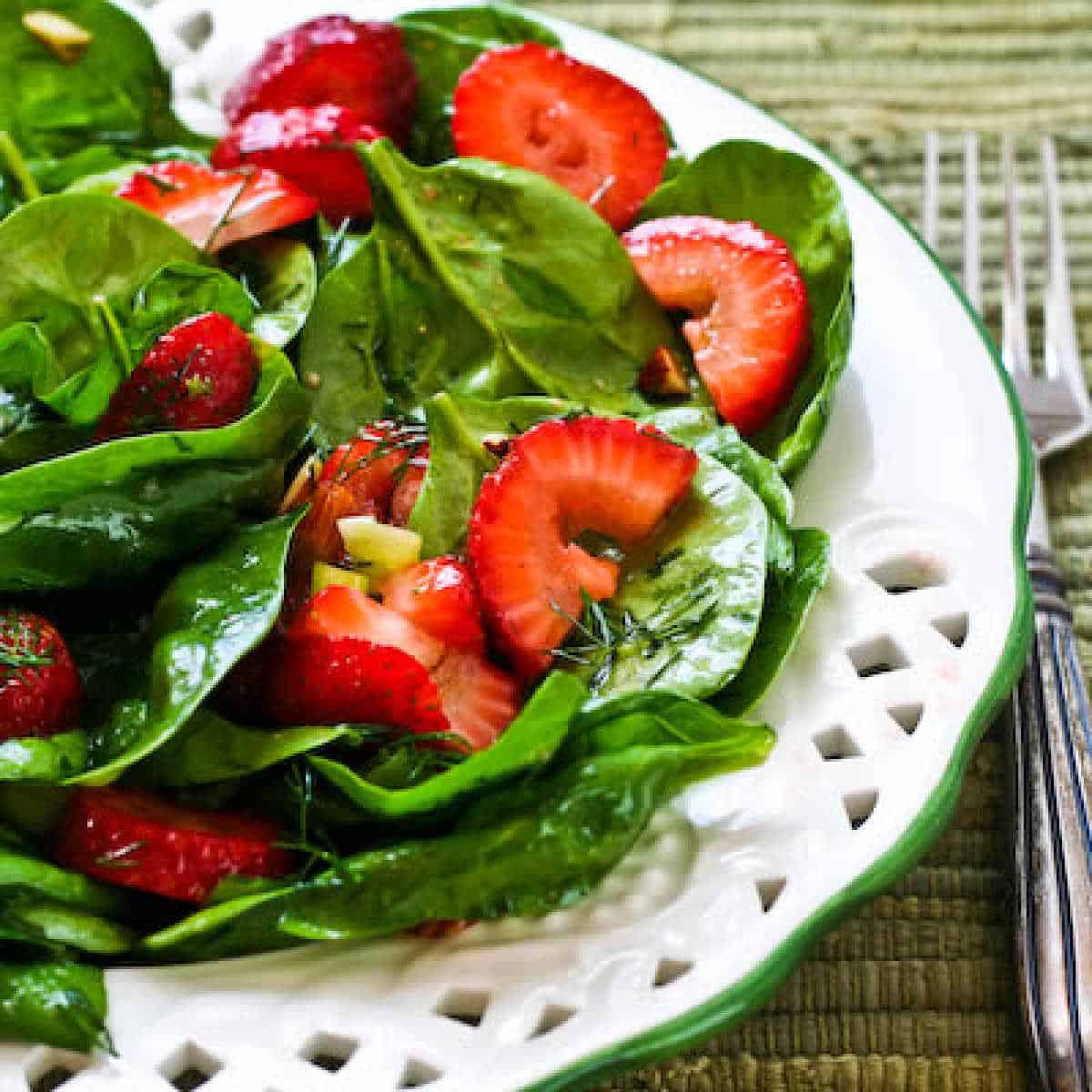 Strawberry and spinach salad displayed on a serving plate