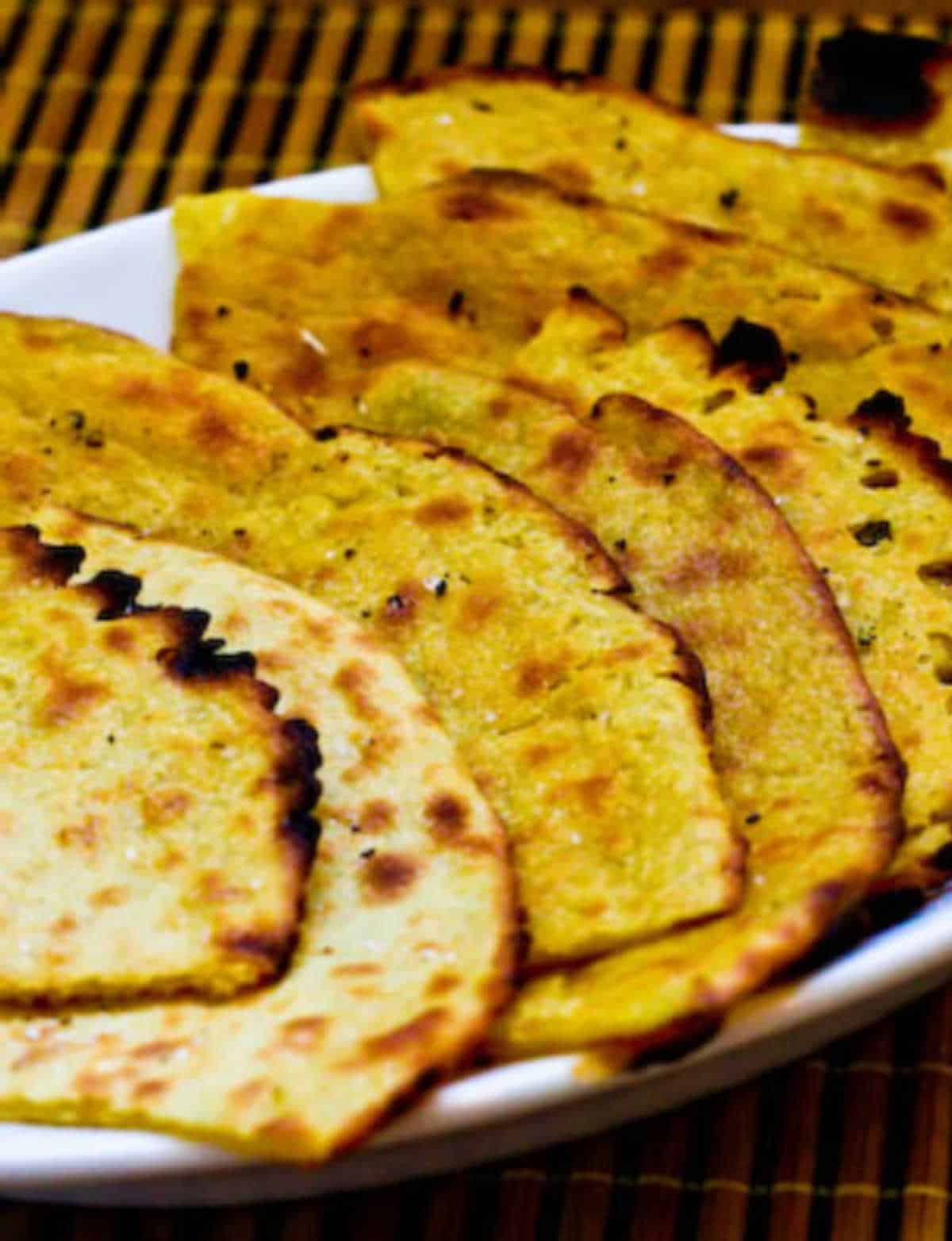 close-up photo of Socca chickpea flatbread on serving plate