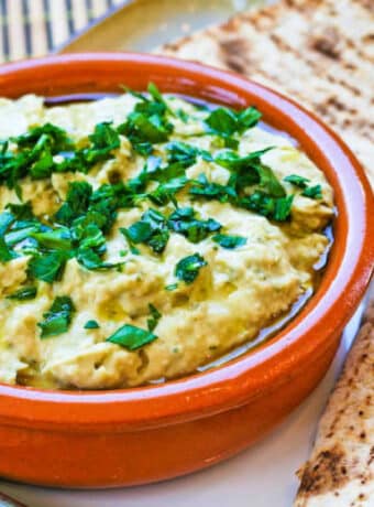 White Bean Hummus in terra cotta bowl with low-carb pita on the side.