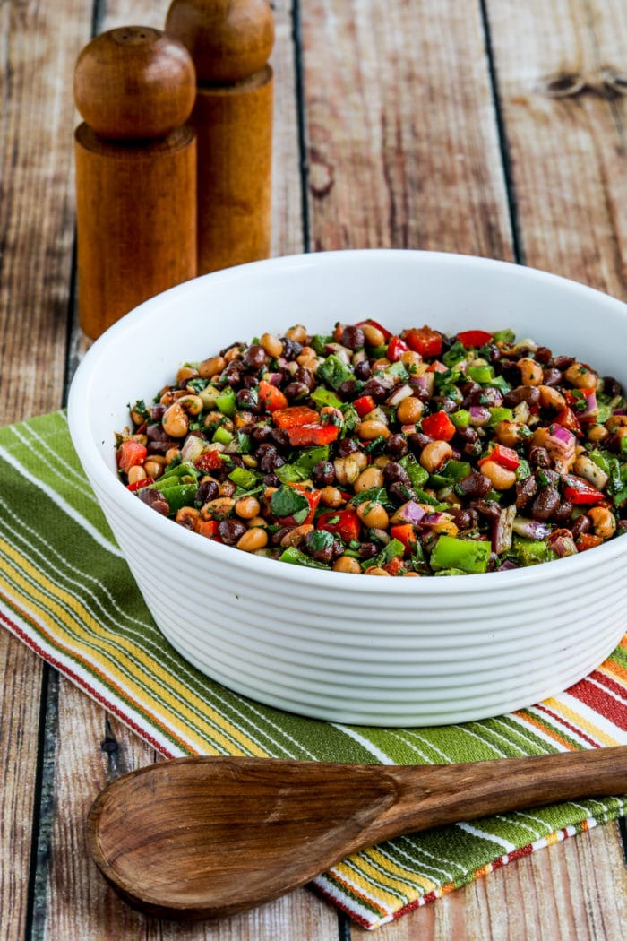 Black Bean Salad with Black-Eyed Peas shown in serving bowl with spoon and salt-pepper shakers
