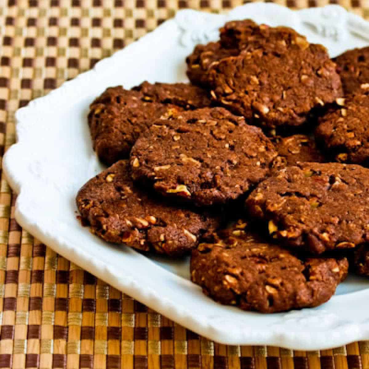 Square image for Sugar-Free Chocolate Pecan Cookies shown on white plate.