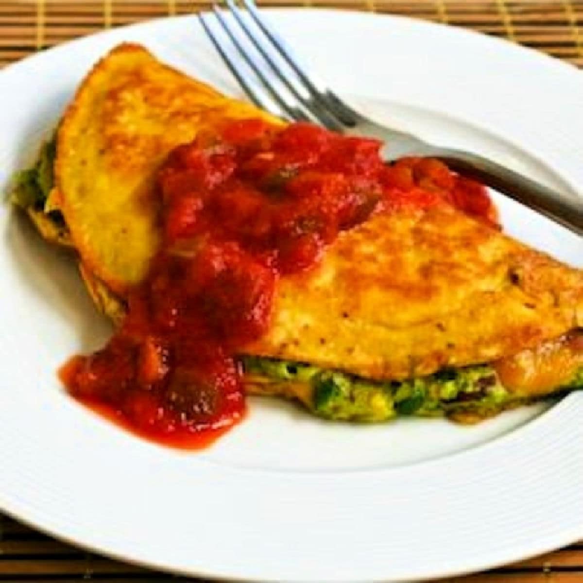 Square image for Southwestern Omelet shown on plate with Guacamole and Salsa.