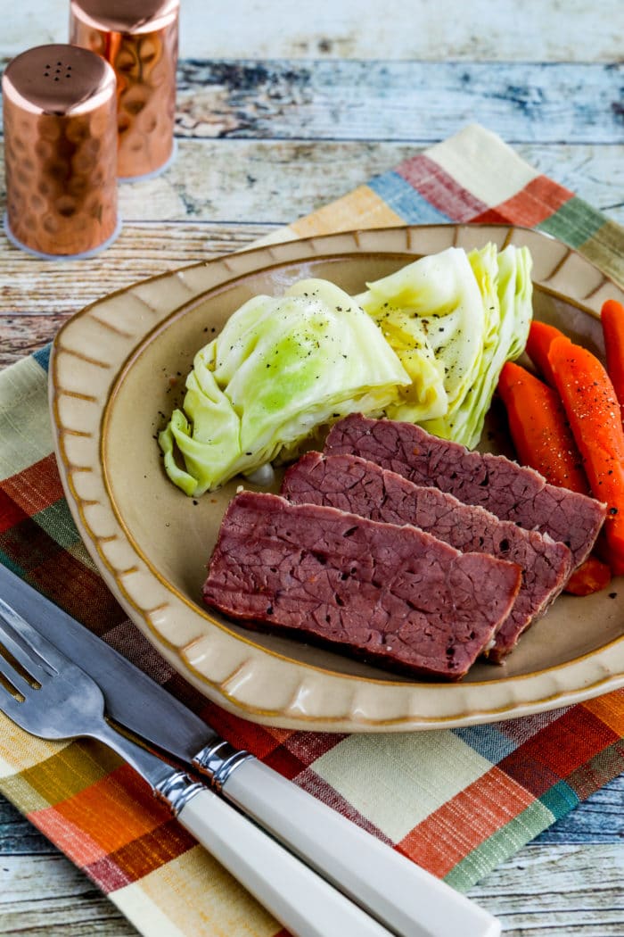 Slow cooker stuffed beef on a plate with cabbage and carrots