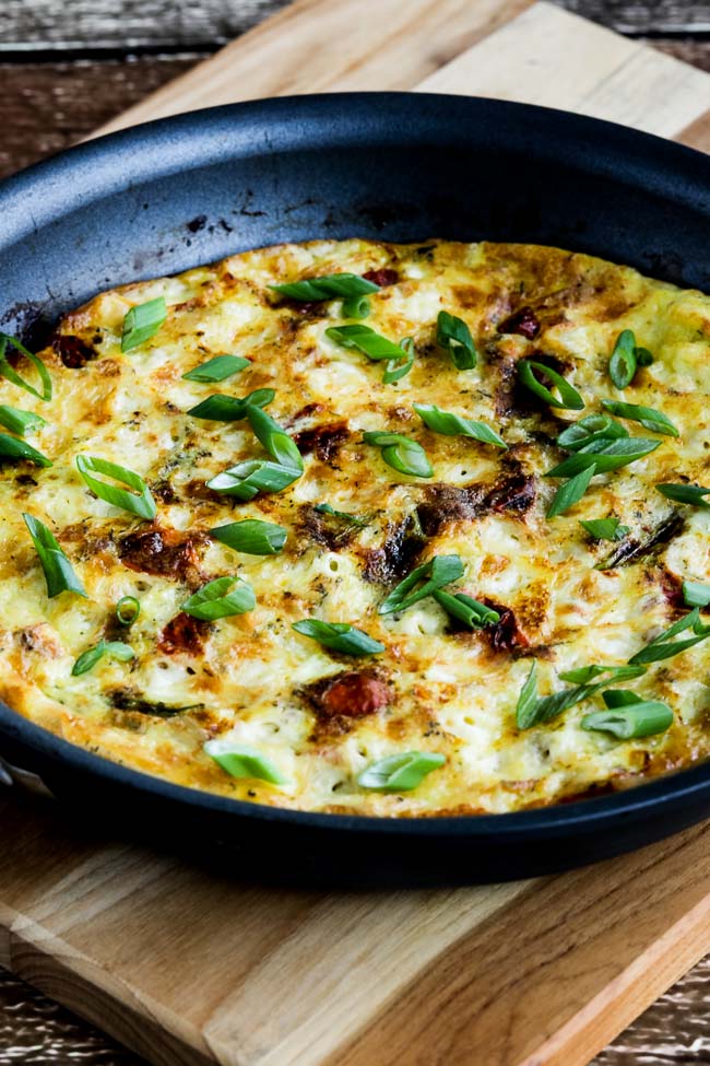 Asparagus Tomato Frittata shown in pan on cutting board