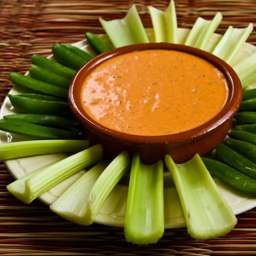 roasted red pepper dip with celery and sugar snap peas