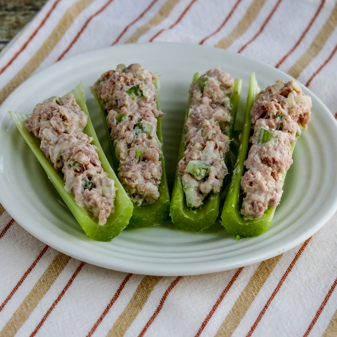 Deviled Ham Spread stuffed into celery shown on plate