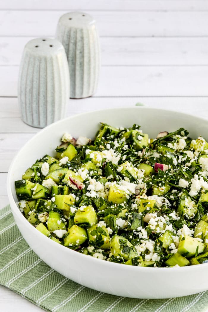 Cucumber Salad with Parsley and Feta shown in serving bowl with salt and pepper shakers