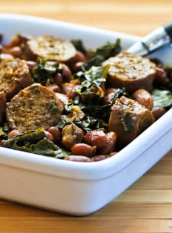 Greens and Beans with Sausage shown in square serving bowl.