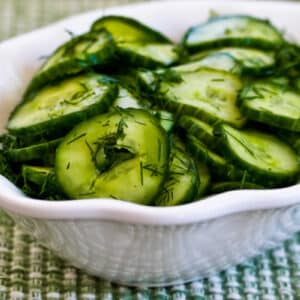 Sweet and Sour Cucumber Salad shown in serving bowl with dill