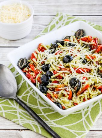 Pesto Pasta Salad in serving bowl, low-carb version made with Palmini pasta