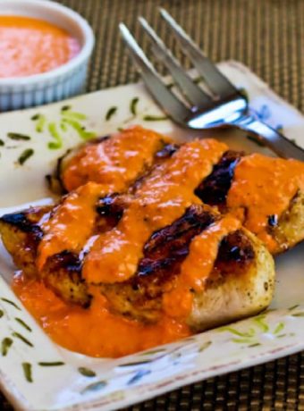 Grilled Garlic Chicken with Red Pepper Aioli on serving plate with sauce