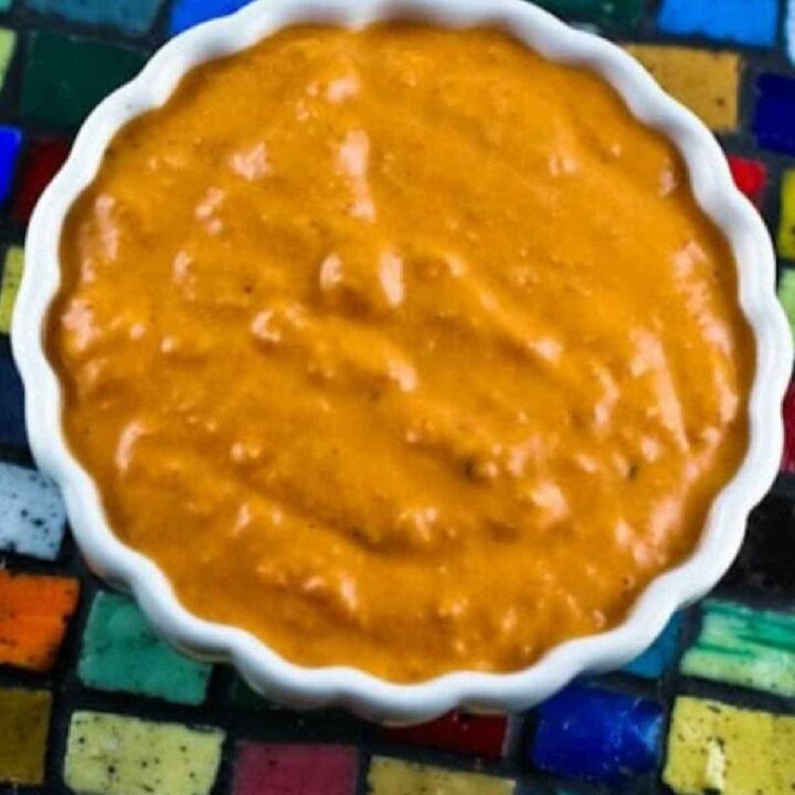 Roasted Red Pepper Sauce in bowl shown on tile mosaic