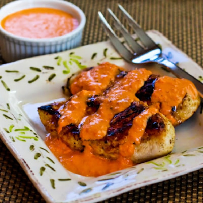 Grilled Garlic Chicken with Red Pepper Aioli chicken with sauce on serving plate