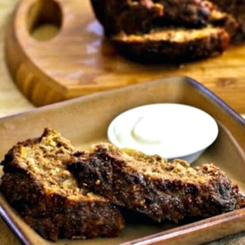 Horseradish Meatloaf with Sour Cream-Horseradish Sauce finished meatloaf with sauce on plate