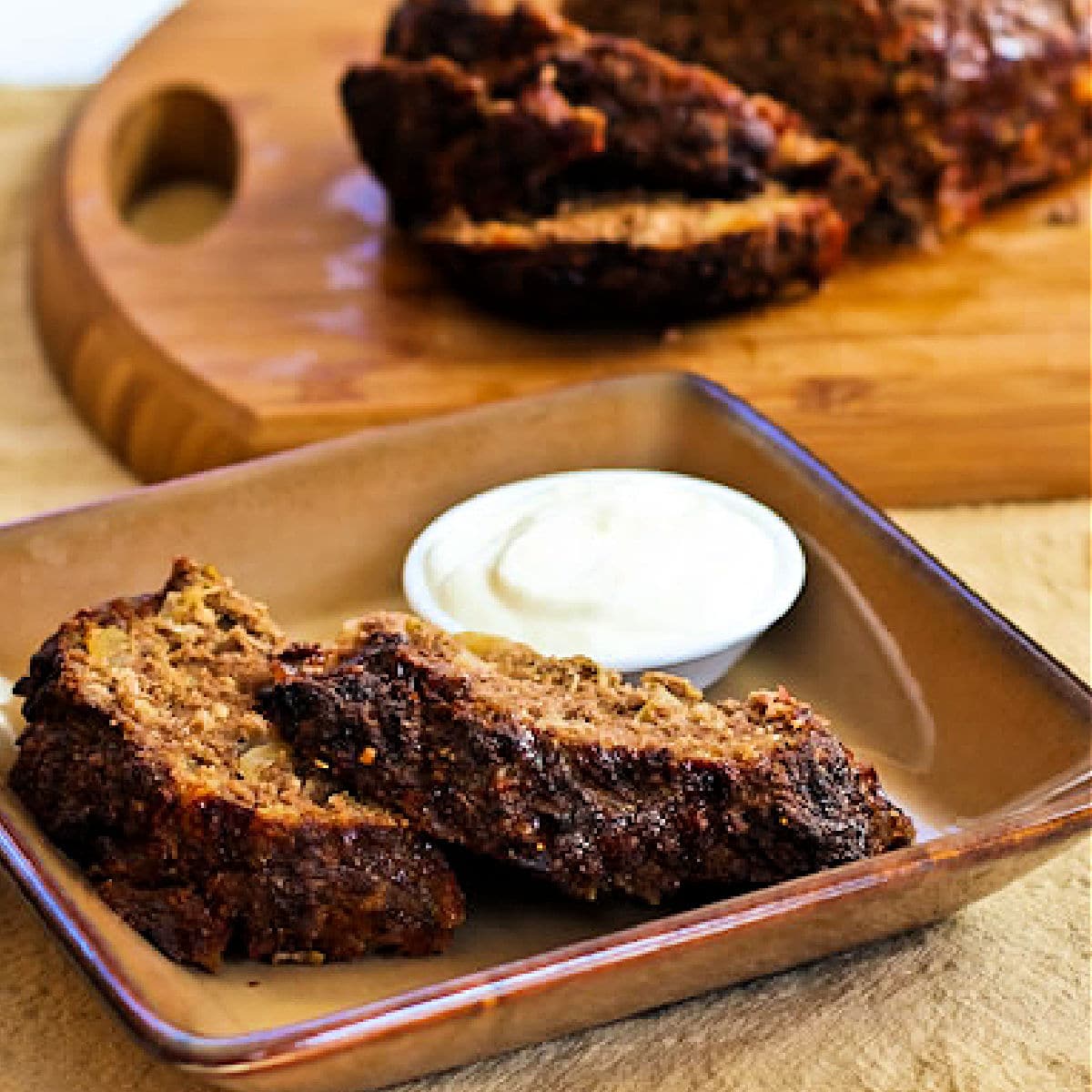 Horseradish Meatloaf (with Sour Cream-Horseradish Sauce) shown on serving plate.