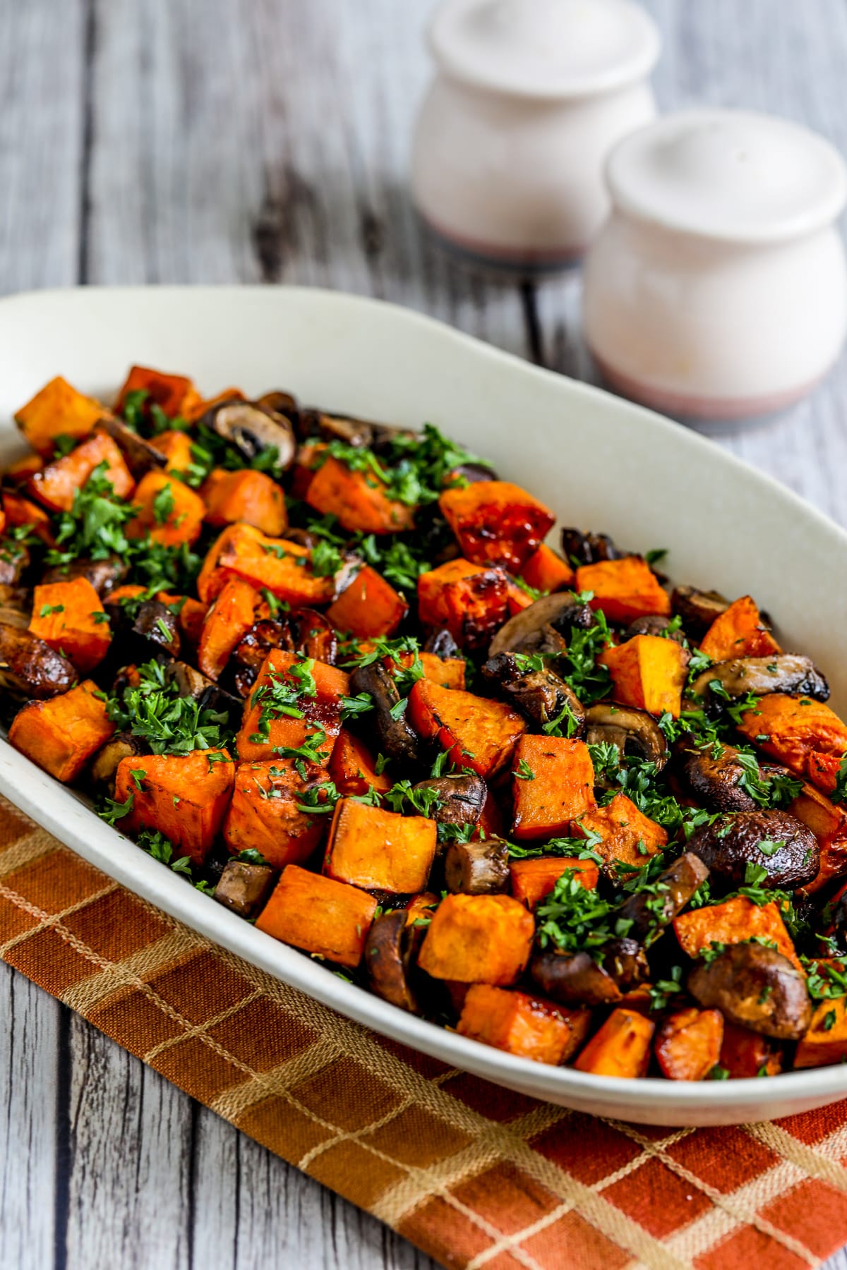 Sweet Potatoes and Mushrooms shown on serving platter with parsley garnish