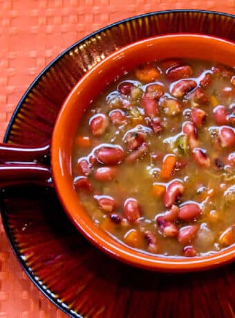 Square image for CrockPot Anasazi Bean Soup shown in bowl on matching plate.