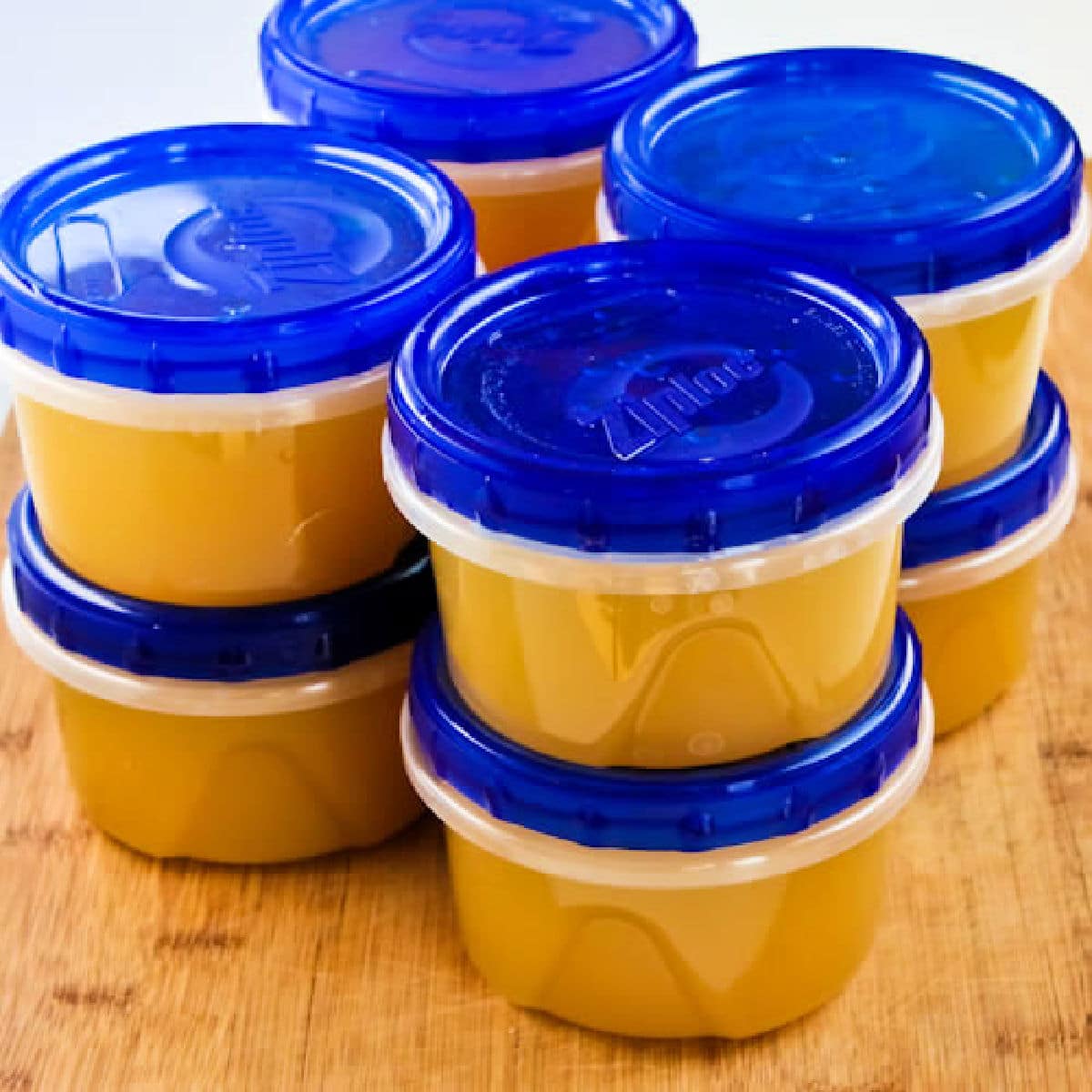 Square image for How to Make Chicken Stock showing stock in containers for freezer.