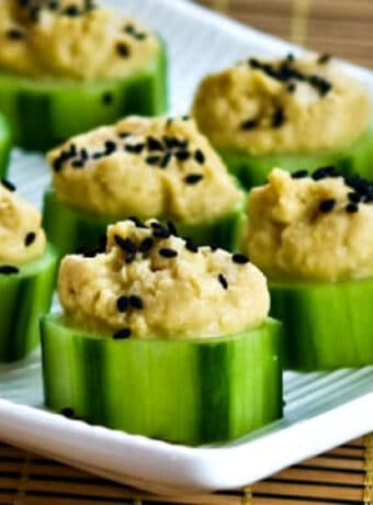 Cucumber Hummus Bites shown on serving dish.