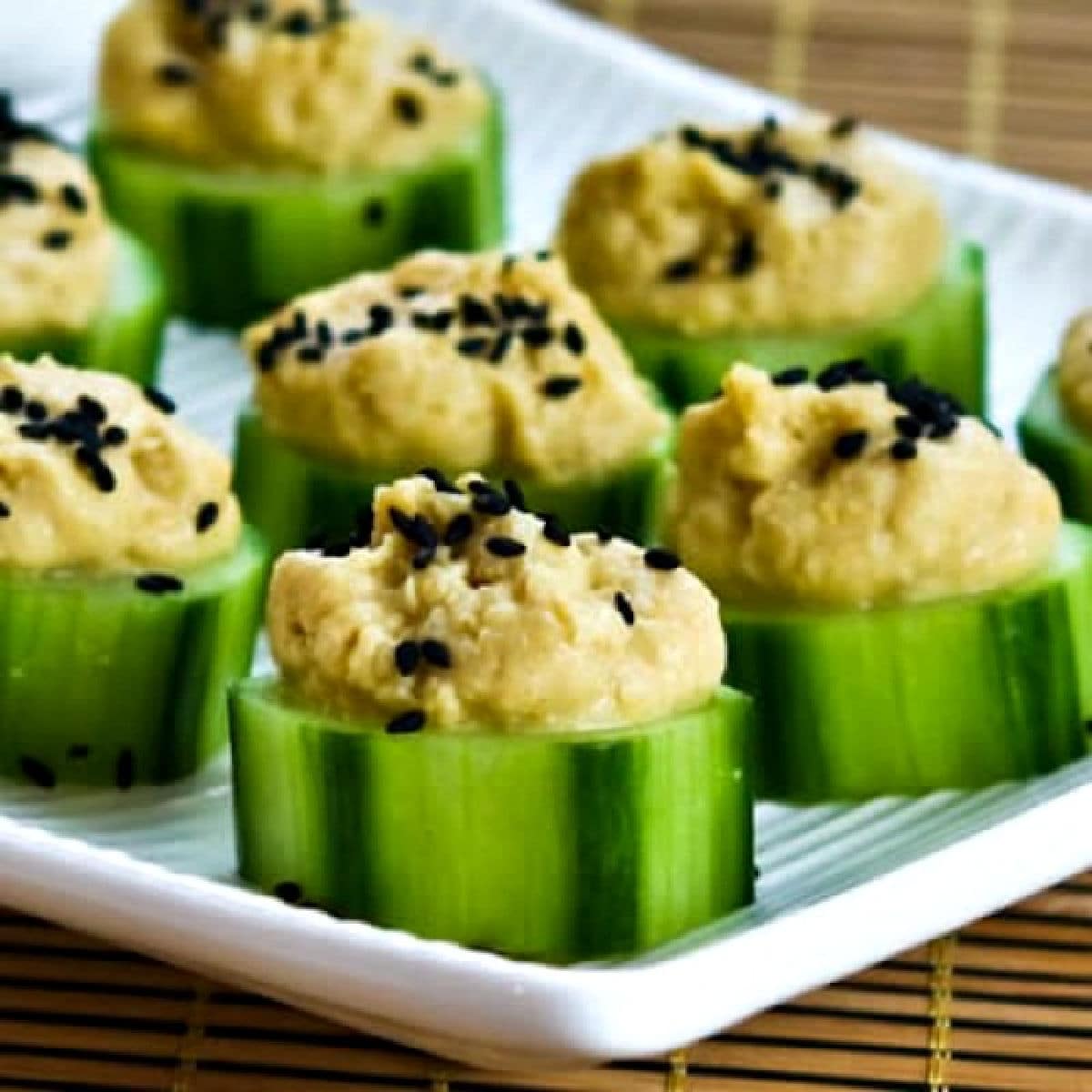 Cucumber Hummus Bites shown on serving dish.