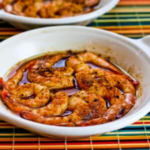 Spicy Broiled Shrimp Recipe shown in two gratin dishes.