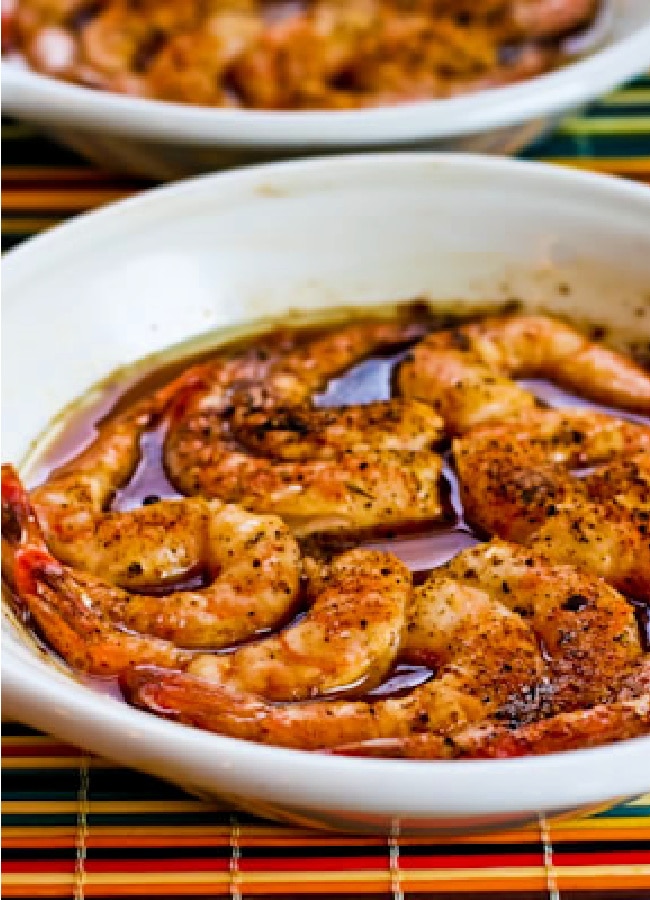 Spicy Broiled Shrimp Recipe shown in two gratin dishes, close-up photo.
