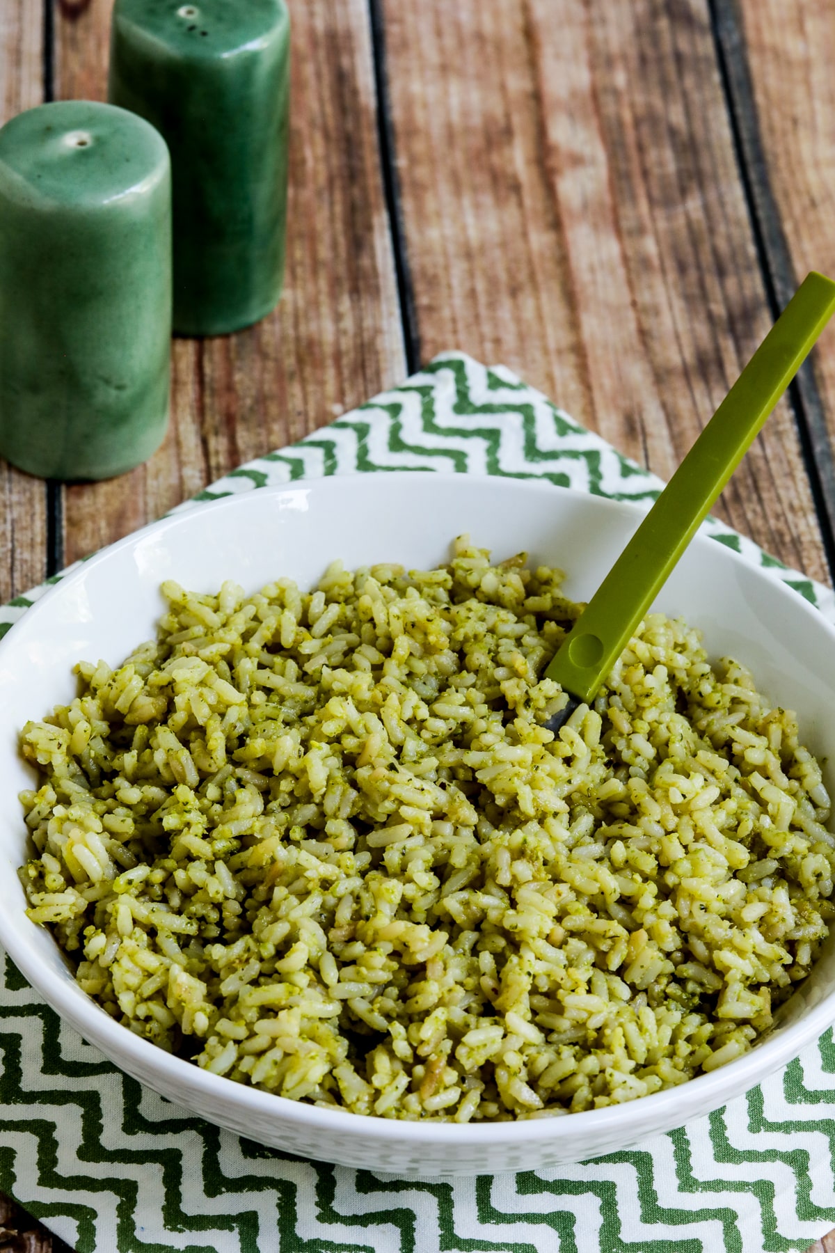 Lemon Pesto Rice Recipe shown in serving bowl with green spoon.