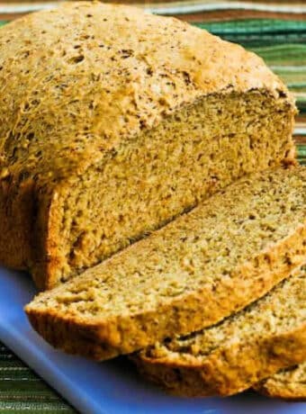Square image for Bread Machine Whole Wheat Bread shown on cutting board with some slices and the rest of the loaf.