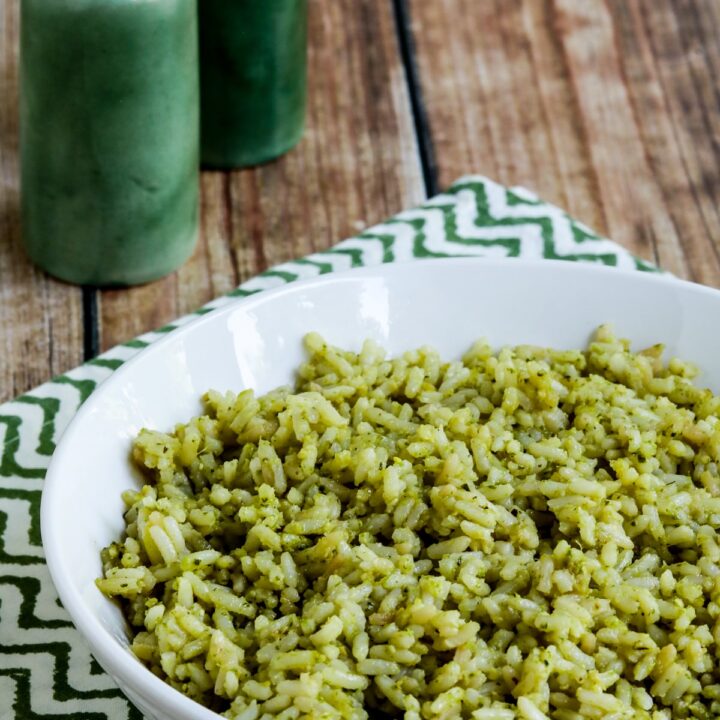 Lemon Pesto Rice Recipe in serving bowl with spoon and green salt-pepper shakers.