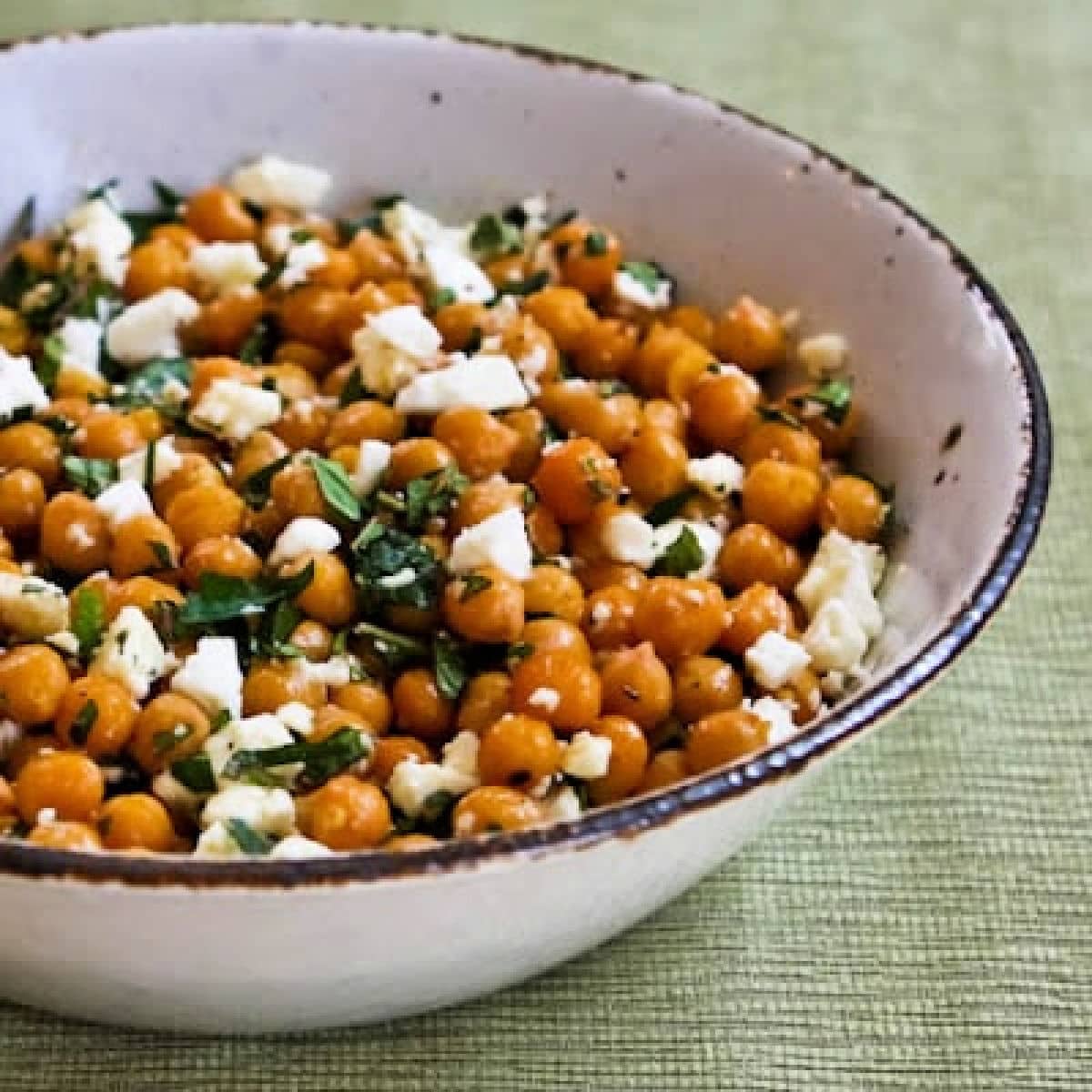 Garlic Roasted Chickpeas with Feta, Mint, and Lemon shown in serving bowl.