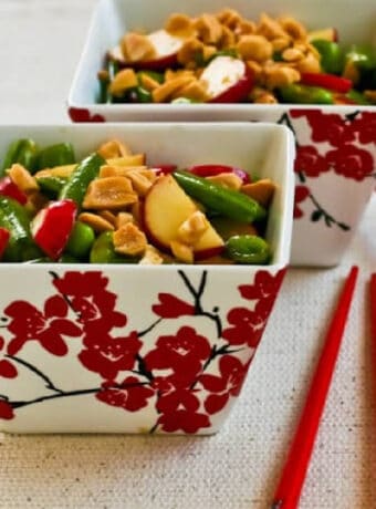 Sugar Snap Pea Salad shown in two cherry blossom bowls with chipsticks