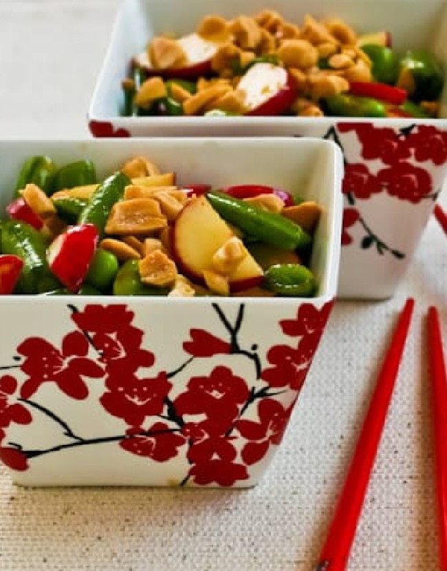 Sugar Snap Pea Salad shown in two cherry blossom bowls with chipsticks