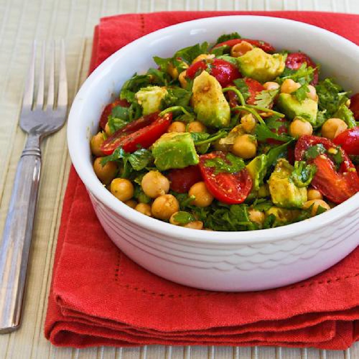 Chickpea Tomato Salad in bowl on red napkin
