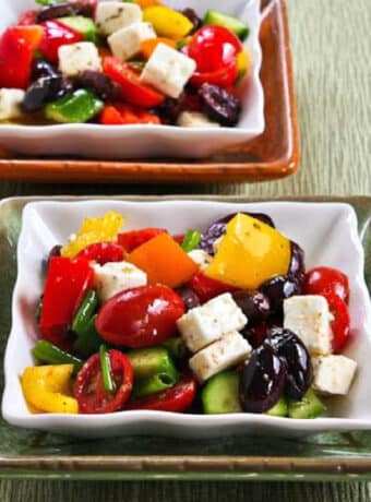 square image of Chopped Greek Salad with Peppers shown on two serving plates