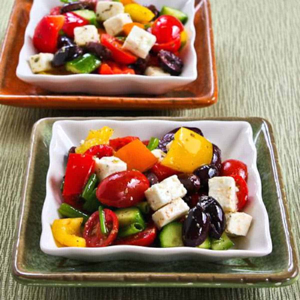 square image of Chopped Greek Salad with Peppers shown on two serving plates