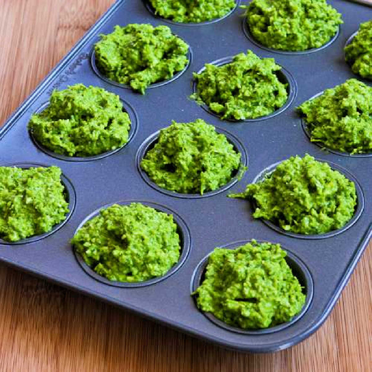 Garlic Scape Pesto with Chard ready to be frozen in mini muffin tin