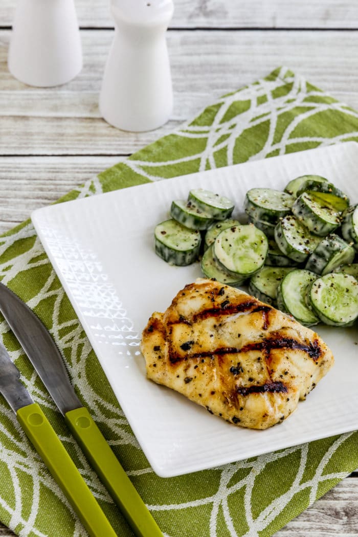 Grilled Cod with Garlic, Basil, and Lemon on serving plate with cucumber salad