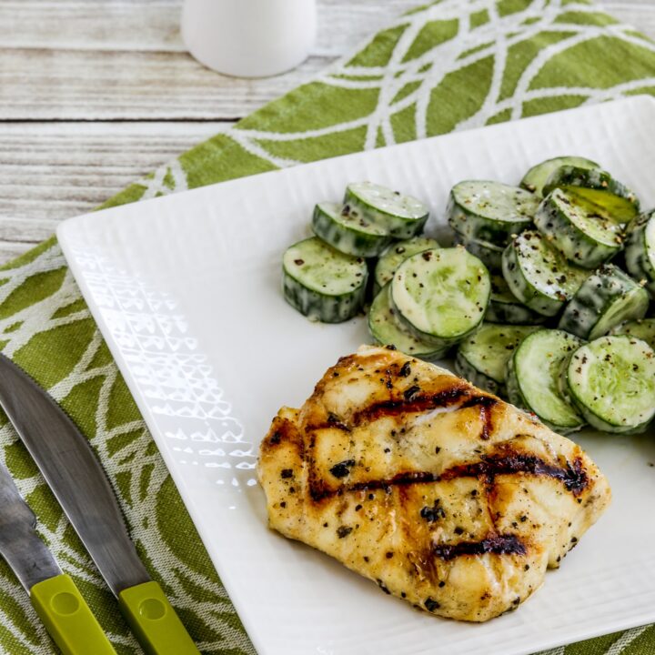 Grilled Cod with Garlic, Basil, and Lemon on serving plate with cucumber salad