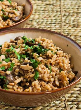 Square image of Barley with Mushrooms shown in two serving bowls.