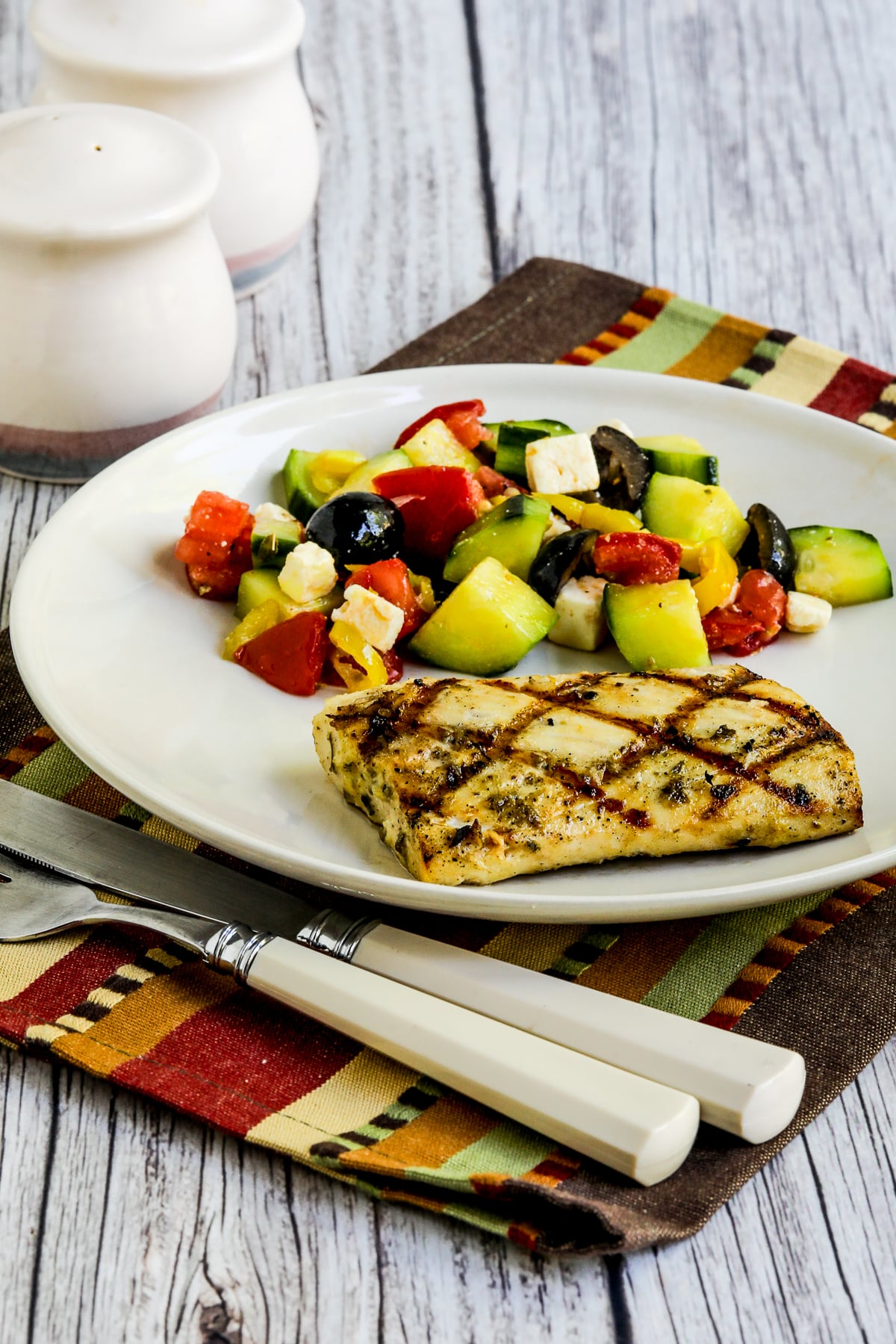Grilled Fish with Lemon and Capers shown on plate with salad.