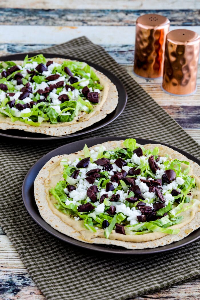 Middle Eastern Tostadas with Hummus and Feta on two serving plates